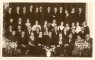 Madonas ģimnāzijas 1934.gada izlaiduma audzēkņi ar pedagogiem skolas zālē. E.Zariņas foto Madonā.